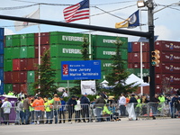 Longshoremen carry signs and demonstrate outside the APM terminals in Elizabeth, New Jersey, United States, on October 1, 2024, as members o...