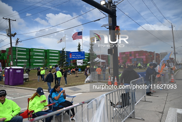 Longshoremen carry signs and demonstrate outside the APM terminals in Elizabeth, New Jersey, United States, on October 1, 2024, as members o...