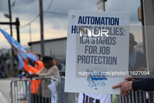 Longshoremen carry signs and demonstrate outside the APM terminals in Elizabeth, New Jersey, United States, on October 1, 2024, as members o...