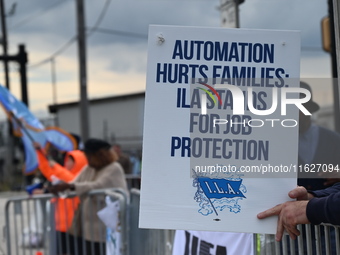 Longshoremen carry signs and demonstrate outside the APM terminals in Elizabeth, New Jersey, United States, on October 1, 2024, as members o...