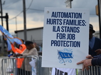 Longshoremen carry signs and demonstrate outside the APM terminals in Elizabeth, New Jersey, United States, on October 1, 2024, as members o...