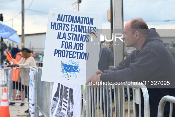 Longshoremen carry signs and demonstrate outside the APM terminals in Elizabeth, New Jersey, United States, on October 1, 2024, as members o...