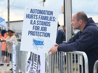 Longshoremen carry signs and demonstrate outside the APM terminals in Elizabeth, New Jersey, United States, on October 1, 2024, as members o...