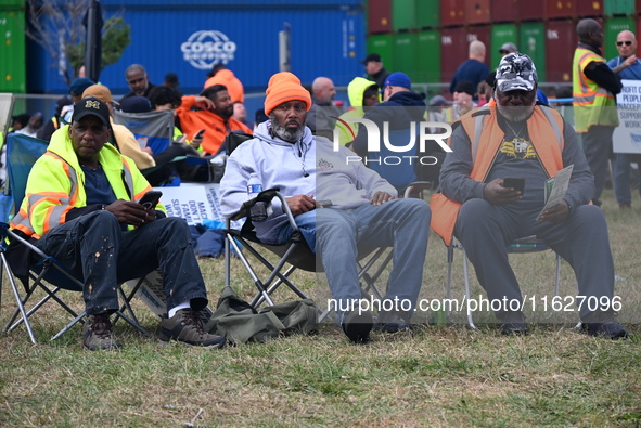 Longshoremen carry signs and demonstrate outside the APM terminals in Elizabeth, New Jersey, United States, on October 1, 2024, as members o...