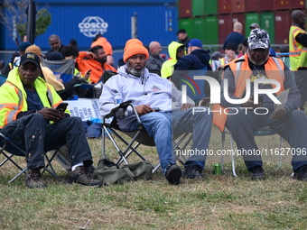 Longshoremen carry signs and demonstrate outside the APM terminals in Elizabeth, New Jersey, United States, on October 1, 2024, as members o...