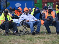 Longshoremen carry signs and demonstrate outside the APM terminals in Elizabeth, New Jersey, United States, on October 1, 2024, as members o...