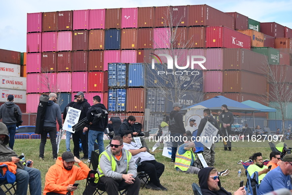 Longshoremen carry signs and demonstrate outside the APM terminals in Elizabeth, New Jersey, United States, on October 1, 2024, as members o...