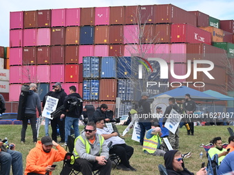 Longshoremen carry signs and demonstrate outside the APM terminals in Elizabeth, New Jersey, United States, on October 1, 2024, as members o...