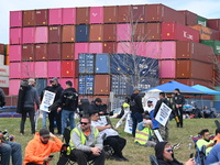 Longshoremen carry signs and demonstrate outside the APM terminals in Elizabeth, New Jersey, United States, on October 1, 2024, as members o...