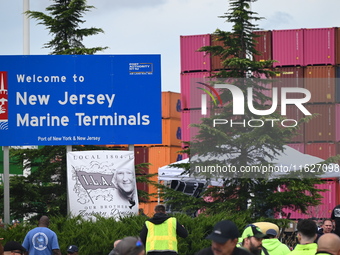 Longshoremen carry signs and demonstrate outside the APM terminals in Elizabeth, New Jersey, United States, on October 1, 2024, as members o...