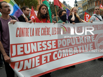 The banner reads 'against costly life, imperialist wars and crackdowns, popular youths united and fighting'. Between 3,000 and 5,000 protest...