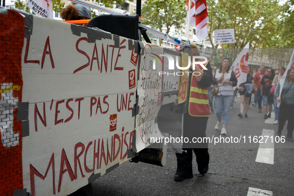 The cardboard on the left reads 'Health isn't a merchandise'. Between 3,000 and 5,000 protesters march in Toulouse, France, on October 1, 20...