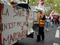 The cardboard on the left reads 'Health isn't a merchandise'. Between 3,000 and 5,000 protesters march in Toulouse, France, on October 1, 20...