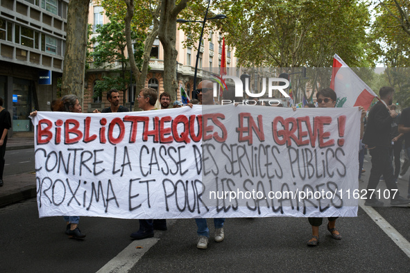 The banner reads 'Angry librarians, against the destruction of public services'. Between 3,000 and 5,000 protesters march in Toulouse, Franc...