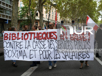 The banner reads 'Angry librarians, against the destruction of public services'. Between 3,000 and 5,000 protesters march in Toulouse, Franc...