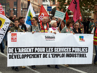 The banner reads 'Money for public services, for industrial jobs'. Between 3,000 and 5,000 protesters march in Toulouse, France, on October...