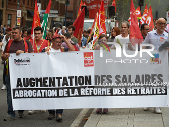 The banner reads 'raise of wages, withdrawal of the retirement reform'. Between 3,000 and 5,000 protesters march in Toulouse, France, on Oct...