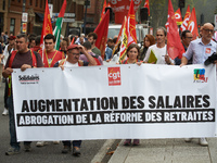 The banner reads 'raise of wages, withdrawal of the retirement reform'. Between 3,000 and 5,000 protesters march in Toulouse, France, on Oct...