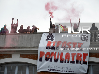 People on the roof display a banner reading 'Popular response'. Between 3,000 and 5,000 protesters march in Toulouse, France, on October 1,...