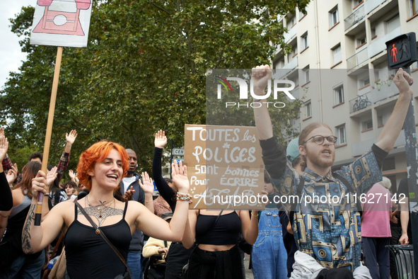 A protester holds a placard reading 'Every police is good to write ACAB'. It is a play on words in French: 'police' means both 'the police'...