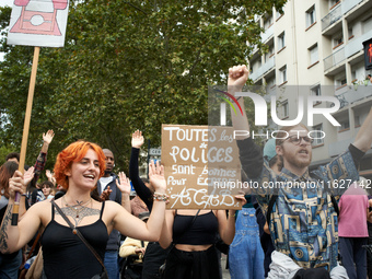 A protester holds a placard reading 'Every police is good to write ACAB'. It is a play on words in French: 'police' means both 'the police'...