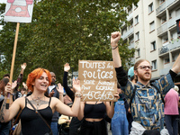 A protester holds a placard reading 'Every police is good to write ACAB'. It is a play on words in French: 'police' means both 'the police'...