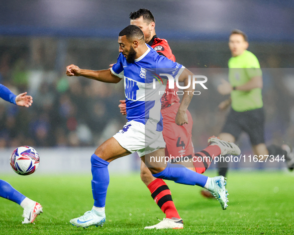 #14, Keshi Anderson of Birmingham races forward with #4, Matty Pearson of Huddersfield on his shoulder during the Sky Bet League 1 match bet...