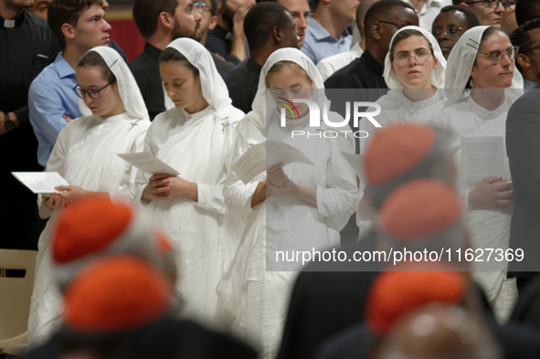 A group of nuns attend a vigil prayer in St. Peter's Basilica ahead of the start of the Synod of Bishops 16th General Assembly, at the Vatic...