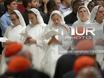 A group of nuns attend a vigil prayer in St. Peter's Basilica ahead of the start of the Synod of Bishops 16th General Assembly, at the Vatic...