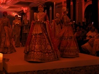 Models present a creation by Indian designer Manish Malhotra to showcase the Handloom Indian Couture collection during a charity event to su...