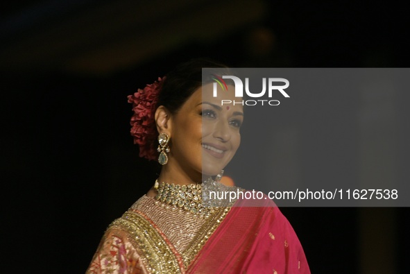 Bollywood actress Sonali Bendre presents a creation by Indian designer Manish Malhotra to showcase the Handloom Indian Couture collection du...