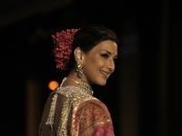 Bollywood actress Sonali Bendre presents a creation by Indian designer Manish Malhotra to showcase the Handloom Indian Couture collection du...