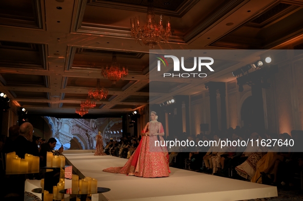 A model presents a creation by Indian designer Manish Malhotra to showcase the Handloom Indian Couture collection during a charity event to...