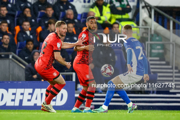 #32, Tom Lees, and #17, Brodie Spencer of Huddersfield battle for possession with #28, Jay Stansfield of Birmingham during the Sky Bet Leagu...