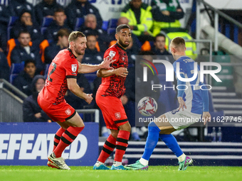 #32, Tom Lees, and #17, Brodie Spencer of Huddersfield battle for possession with #28, Jay Stansfield of Birmingham during the Sky Bet Leagu...