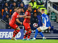 #32, Tom Lees, and #17, Brodie Spencer of Huddersfield battle for possession with #28, Jay Stansfield of Birmingham during the Sky Bet Leagu...