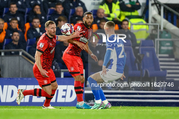 #32, Tom Lees, and #17, Brodie Spencer of Huddersfield battle for possession with #28, Jay Stansfield of Birmingham during the Sky Bet Leagu...