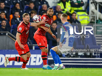 #32, Tom Lees, and #17, Brodie Spencer of Huddersfield battle for possession with #28, Jay Stansfield of Birmingham during the Sky Bet Leagu...