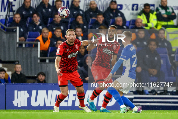 #32, Tom Lees, and #17, Brodie Spencer of Huddersfield battle for possession with #28, Jay Stansfield of Birmingham during the Sky Bet Leagu...