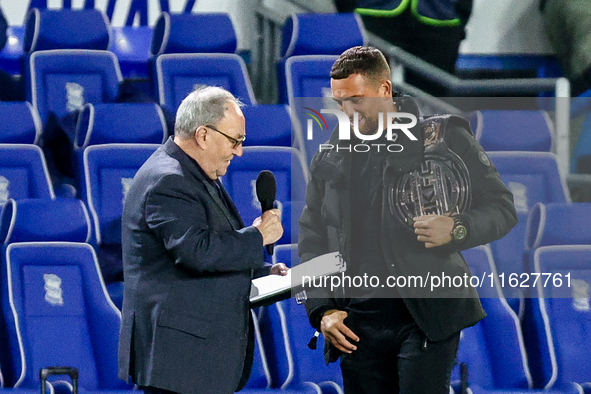 Local celebrity and bare-knuckle champion Connor Tierney (right) is interviewed at the interval during the Sky Bet League 1 match between Bi...