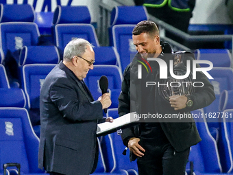 Local celebrity and bare-knuckle champion Connor Tierney (right) is interviewed at the interval during the Sky Bet League 1 match between Bi...