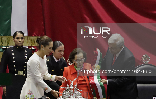 Claudia Sheinbaum (bone-coloured dress) is sworn in as President of Mexico and receives the presidential sash from Andres Manuel Lopez Obrad...