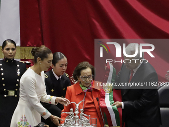 Claudia Sheinbaum (bone-coloured dress) is sworn in as President of Mexico and receives the presidential sash from Andres Manuel Lopez Obrad...