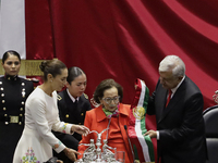 Claudia Sheinbaum (bone-coloured dress) is sworn in as President of Mexico and receives the presidential sash from Andres Manuel Lopez Obrad...