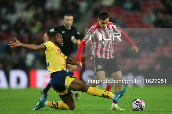 Derby County's Ryan Nyambe tackles Sunderland's Nazariy Rusyn during the Sky Bet Championship match between Sunderland and Derby County at t...