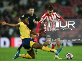 Derby County's Ryan Nyambe tackles Sunderland's Nazariy Rusyn during the Sky Bet Championship match between Sunderland and Derby County at t...