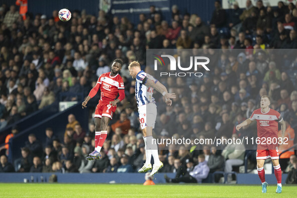 West Bromwich Albion's Uros Racic heads clear from Middlesbrough's Emmanuel Latte Lath during the Sky Bet Championship match between West Br...