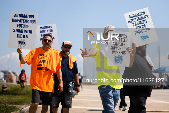 Dockworkers and their supporters hold signs during a strike outside the Bayport Container Terminal in Seabrook, Texas, on October 1, 2024. 