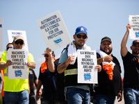 Dockworkers and their supporters hold signs during a strike outside the Bayport Container Terminal in Seabrook, Texas, on October 1, 2024. (