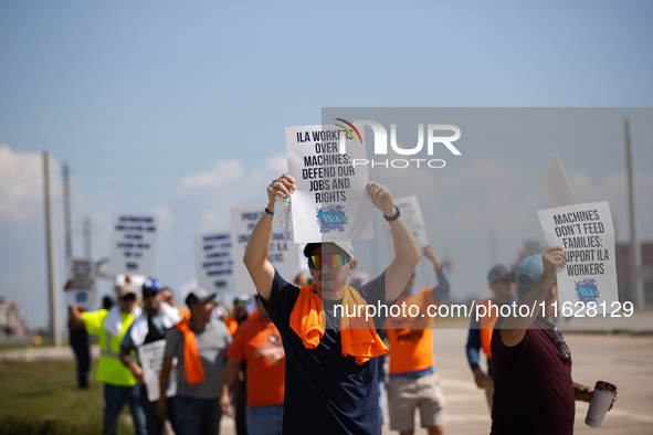 Dockworkers and their supporters hold signs during a strike outside the Bayport Container Terminal in Seabrook, Texas, on October 1, 2024. 